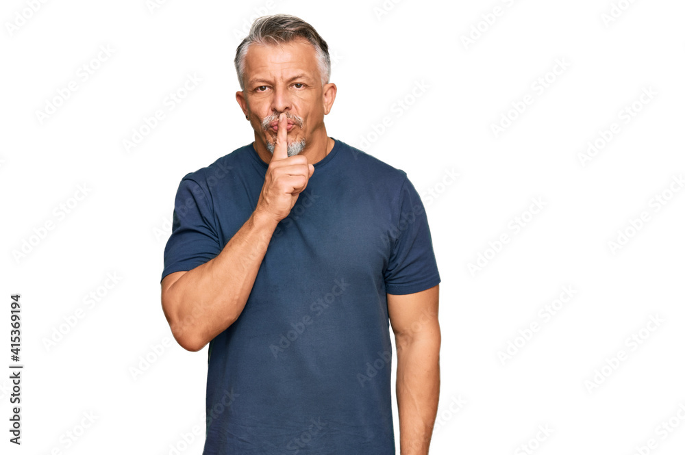 Middle age grey-haired man wearing casual clothes asking to be quiet with finger on lips. silence and secret concept. Middle age grey-haired man wearing casual clothes asking to be quiet with finger on lips. silence and secret concept.