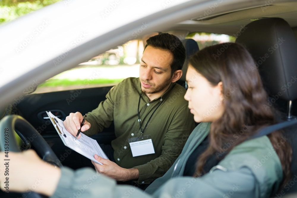 Adolescent girl checking her score on the driving test Adolescent girl checking her score on the driving test