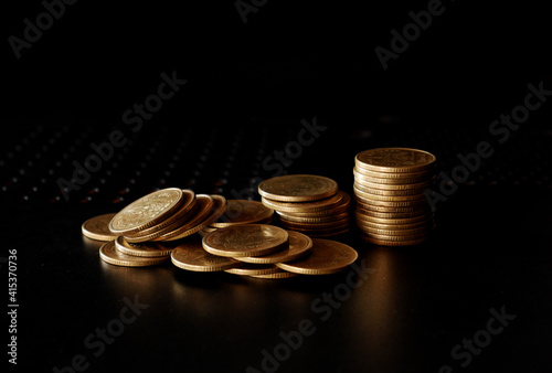 stacks of gold coin on black background concept saving money