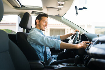 Latin male driver using a touchscreen on the car