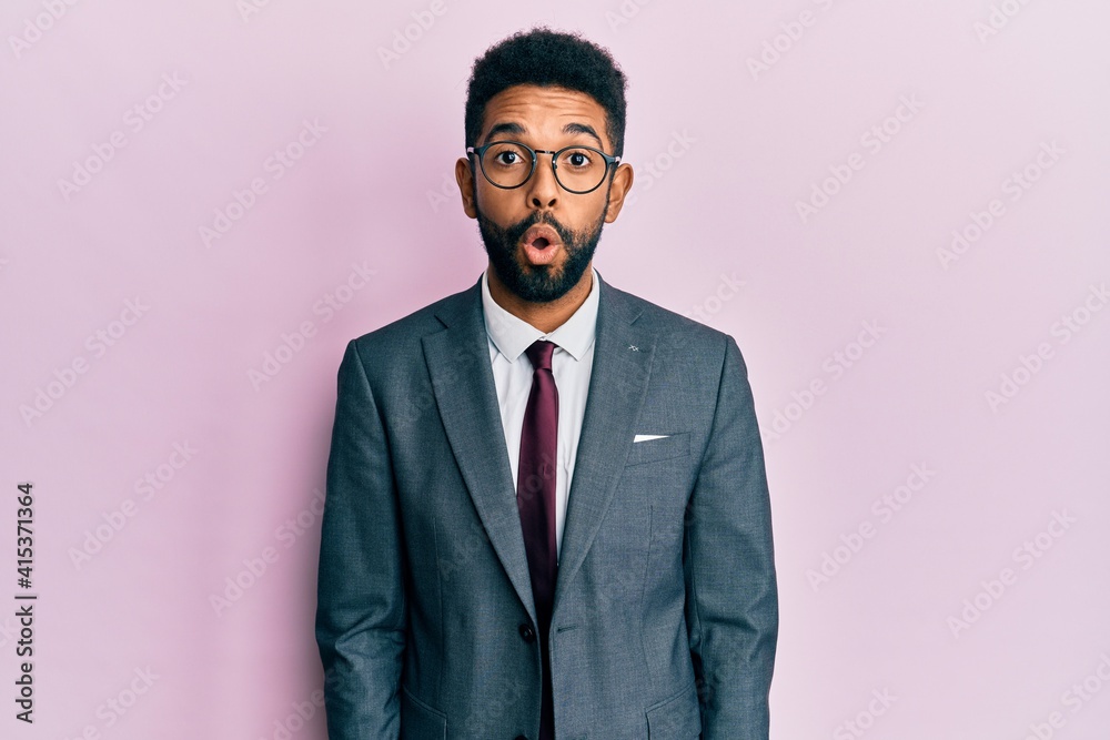 Handsome hispanic business man with beard wearing business suit and tie afraid and shocked with surprise expression, fear and excited face. Handsome hispanic business man with beard wearing business suit and tie afraid and shocked with surprise expression, fear and excited face.