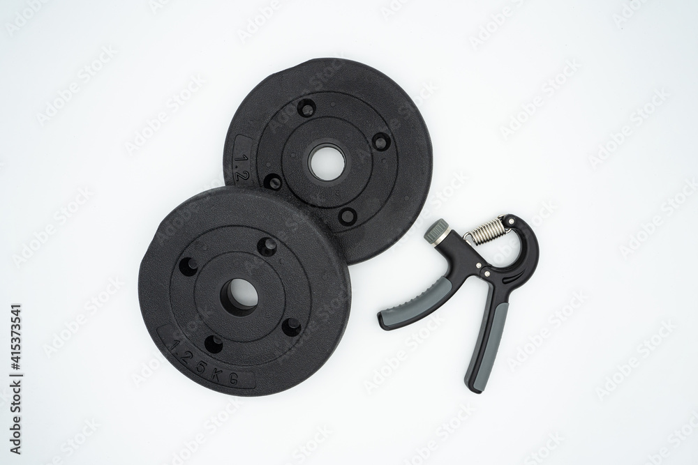 Concept image for healthy home training with grip and dumbbells Concept image for healthy home training with grip and dumbbells