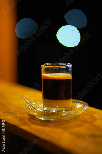 JENEPONTO INDONESIA 19 February 2020: Brew a mixture of coffee and milk in a glass at night photo