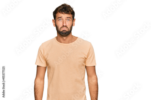 Handsome young man with beard wearing casual tshirt depressed and worry for distress, crying angry and afraid. sad expression.