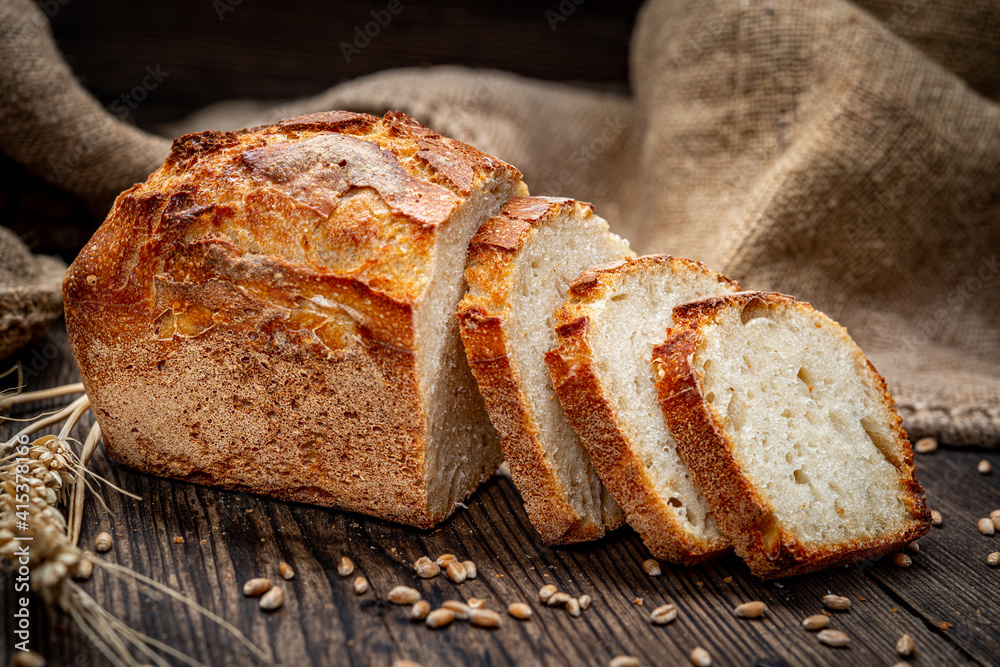 Freshly baked traditional bread on wooden table. Freshly baked traditional bread on wooden table.