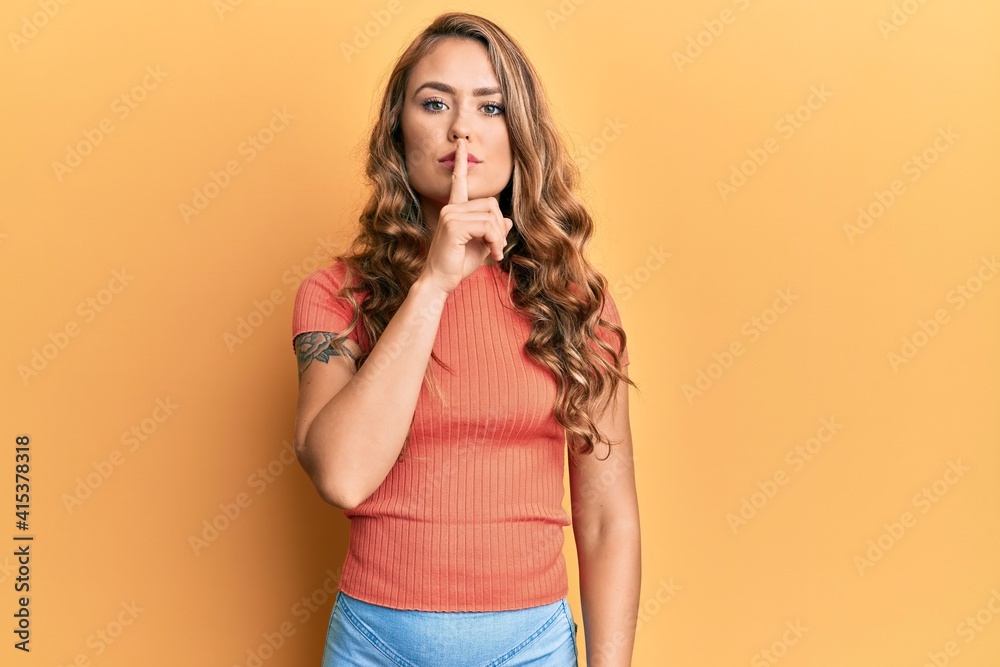Young blonde girl wearing casual clothes asking to be quiet with finger on lips. silence and secret concept. Young blonde girl wearing casual clothes asking to be quiet with finger on lips. silence and secret concept.