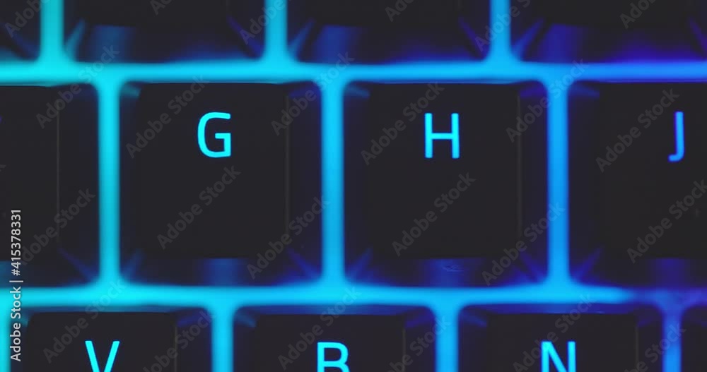 Closeup of illuminated mechanical keyboard keys in motion