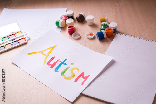 Creative design for april 2, autism world awareness day. Painting word autism with paints