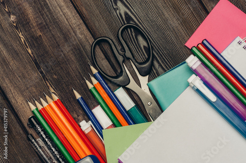 office desk with stationery and pencils scissors paper markers