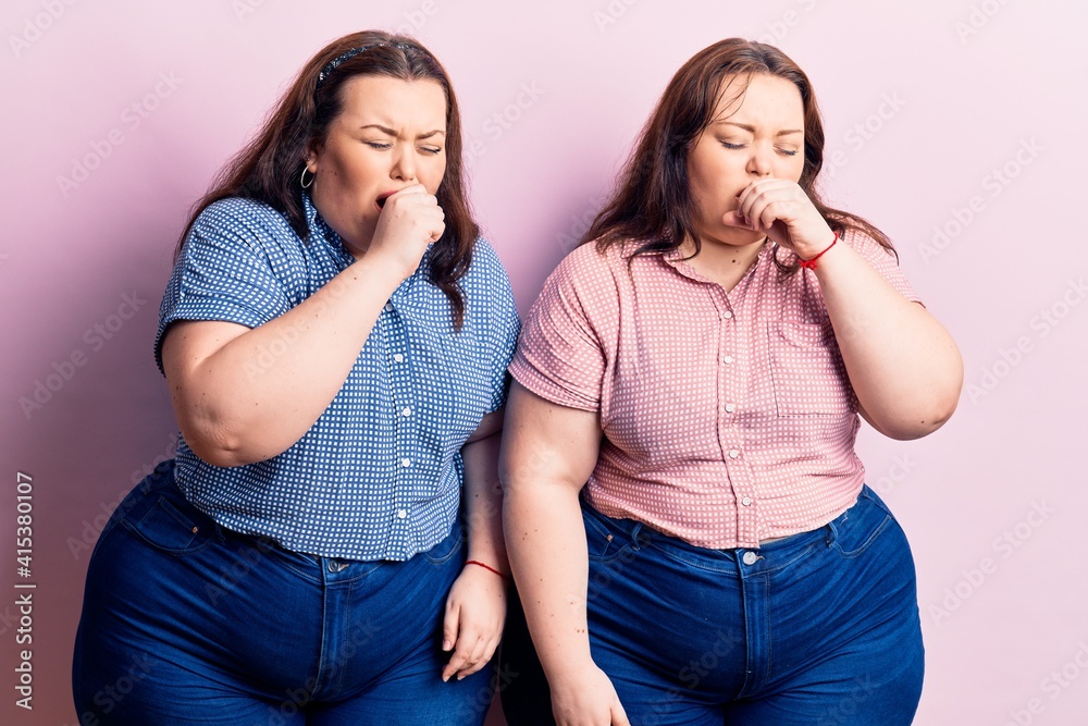 Young plus size twins wearing casual clothes feeling unwell and coughing as symptom for cold or bronchitis. health care concept. Young plus size twins wearing casual clothes feeling unwell and coughing as symptom for cold or bronchitis. health care concept.