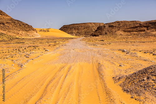 Beautiful landscape of sand dunes in Egypt. Sahara Desert. Background of orange sand wave. Africa desert