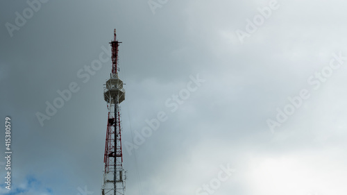 Telecommunication tower against the background of a gloomy gray sky, cell antenna, transmitter. TV tower © borislav15
