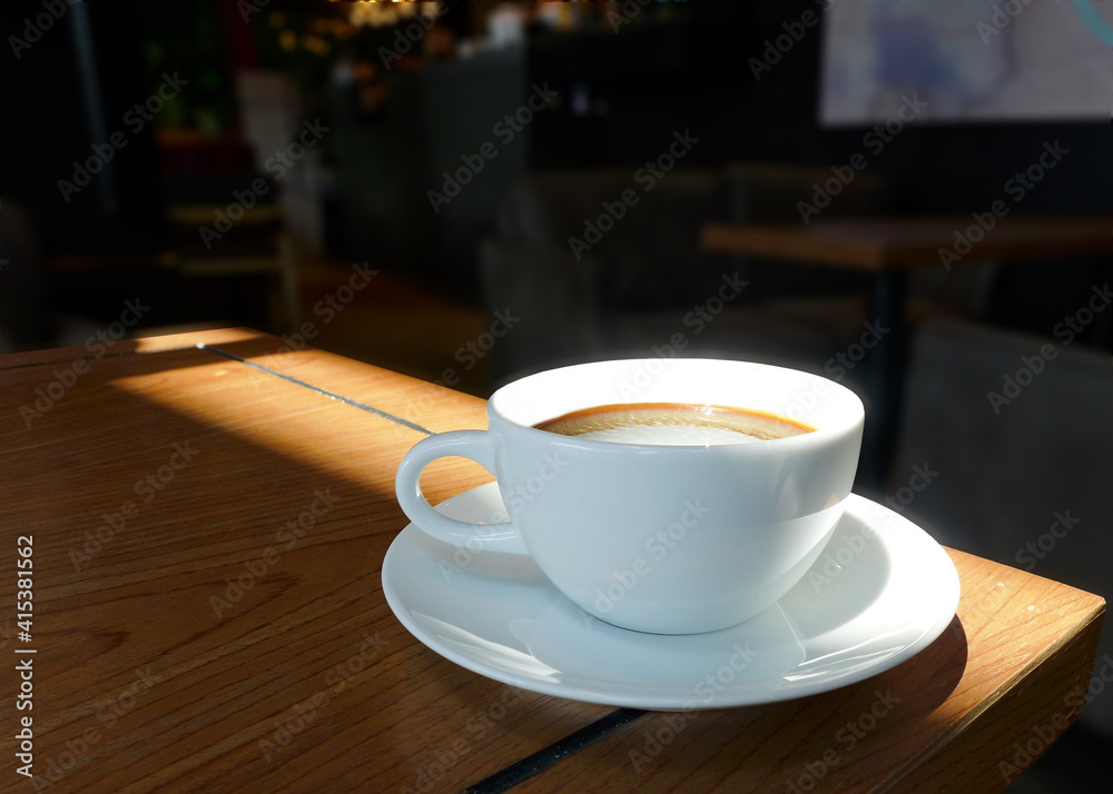 Cup of black coffee on old wooden desk