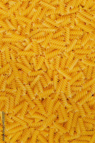 Dry pasta fusilli background. Italian food. Copy space.