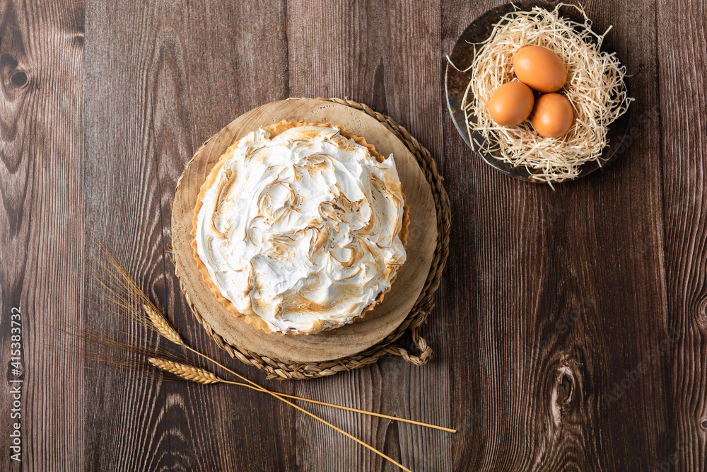 Lemon pie on top of log and wooden table. zenithal view Lemon pie on top of log and wooden table. zenithal view