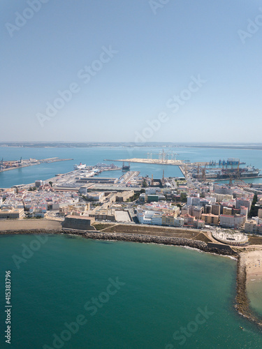 Drone panoramic view of Cadiz City. View of the south part of the city. In background the commercial harbour. Costa de Luz - Spain