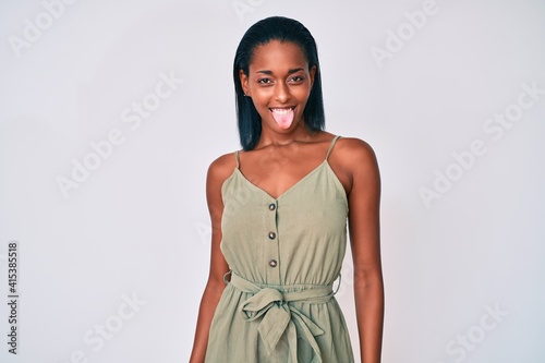 Young african american woman wearing casual clothes sticking tongue out happy with funny expression. emotion concept.