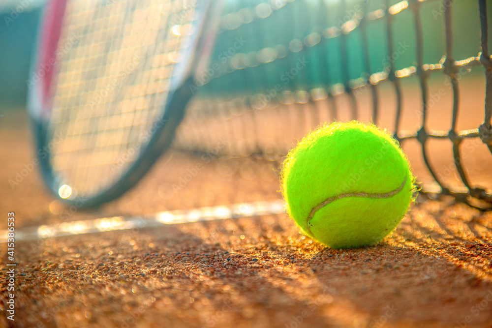 Tennis racket and tennis ball on clay court