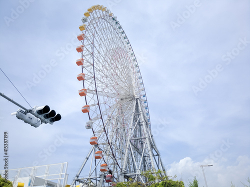 OSAKA, JAPAN - APRIL 4, 2018: large Tenpozan Ferris Wheel with a diameter of 100m and a height of 112.5m. It is one of the largest in the world.