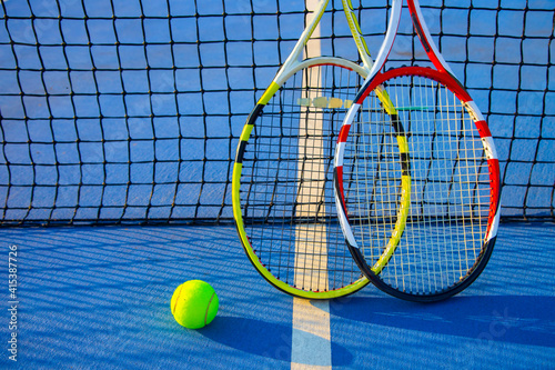 Tennis racket and ball on the blue-coated court © Павел Мещеряков