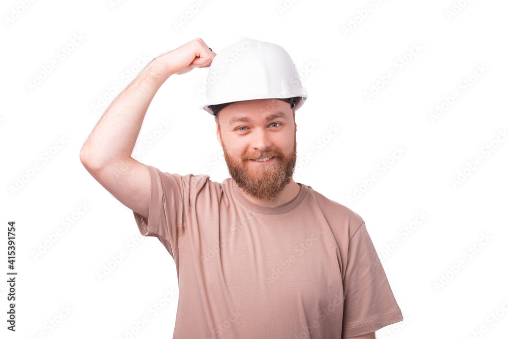 Joyful bearded hipster engineer wearing hard had for safety Joyful bearded hipster engineer wearing hard had for safety