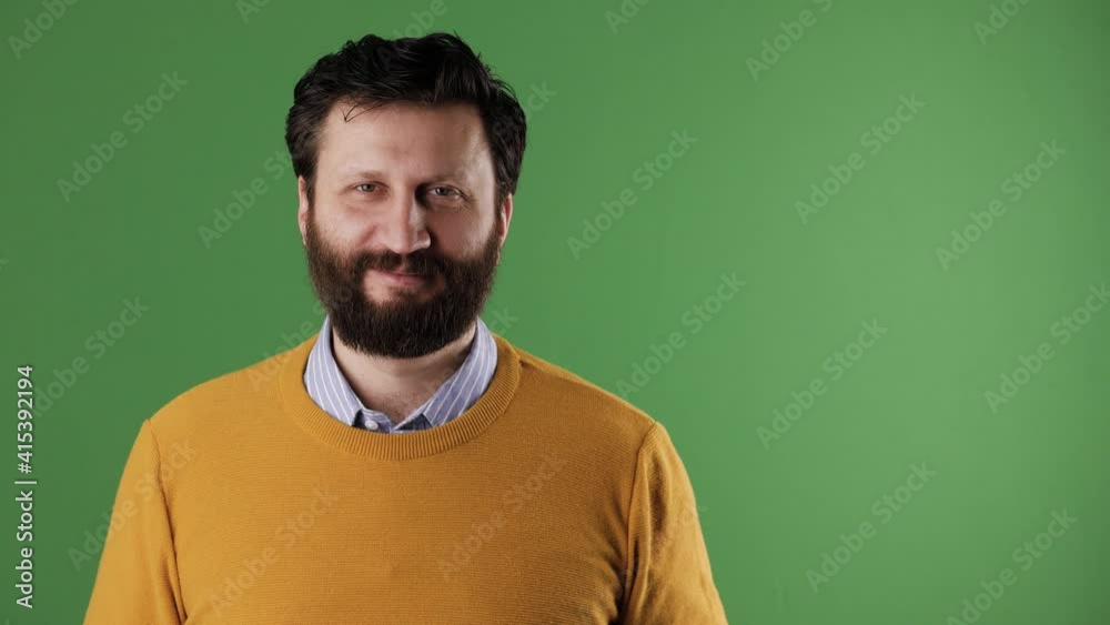 Man holding number 50 sign. Cheerful white bearded good-looking man in yellow sweater shows number fifty on white sheet. Chrome key, green screen, copy space Man holding number 50 sign. Cheerful white bearded good-looking man in yellow sweater shows number fifty on white sheet. Chrome key, green screen, copy space