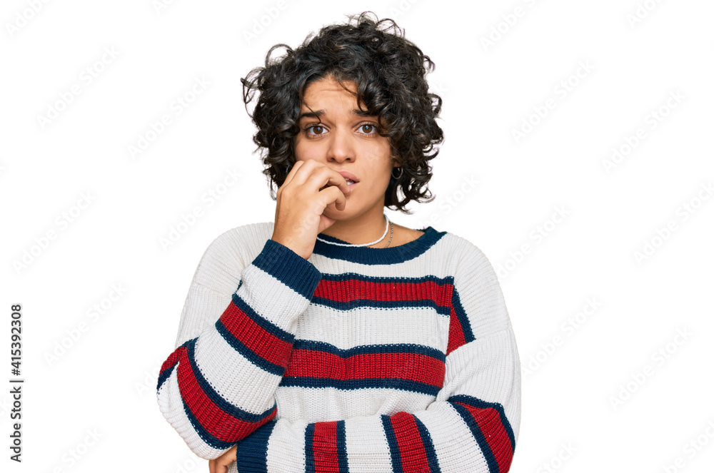 Young hispanic woman with curly hair wearing casual clothes looking stressed and nervous with hands on mouth biting nails. anxiety problem. Young hispanic woman with curly hair wearing casual clothes looking stressed and nervous with hands on mouth biting nails. anxiety problem.