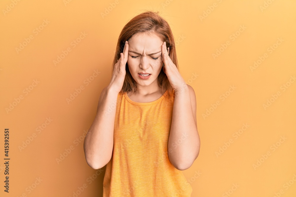 Young caucasian woman wearing casual style with sleeveless shirt with hand on head for pain in head because stress. suffering migraine. Young caucasian woman wearing casual style with sleeveless shirt with hand on head for pain in head because stress. suffering migraine.