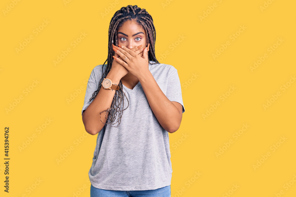 Young african american woman with braids wearing casual clothes shocked covering mouth with hands for mistake. secret concept. Young african american woman with braids wearing casual clothes shocked covering mouth with hands for mistake. secret concept.