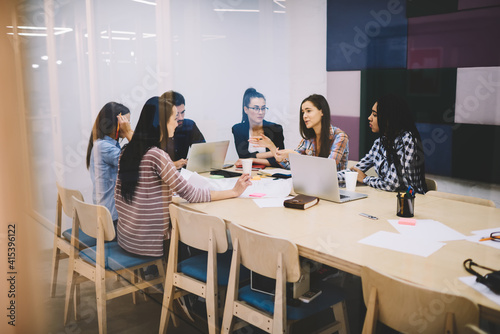 Coworkers having meeting and talking during workday