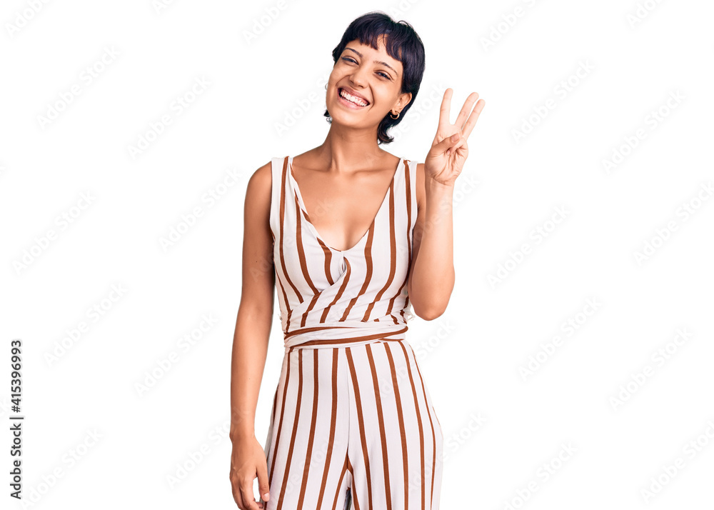 Young brunette woman with short hair wearing summer outfit showing and pointing up with fingers number three while smiling confident and happy. Young brunette woman with short hair wearing summer outfit showing and pointing up with fingers number three while smiling confident and happy.