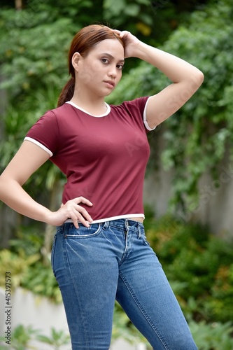 Posing Young Asian Adult Female Wearing Jeans At Park