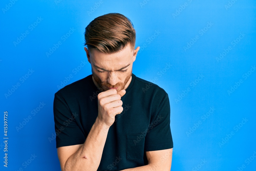 Young redhead man wearing casual black t shirt feeling unwell and coughing as symptom for cold or bronchitis. health care concept. Young redhead man wearing casual black t shirt feeling unwell and coughing as symptom for cold or bronchitis. health care concept.