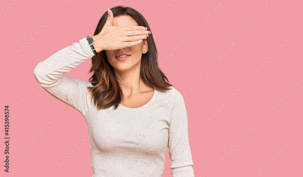 Young brunette woman wearing casual clothes and glasses smiling and laughing with hand on face covering eyes for surprise. blind concept. Young brunette woman wearing casual clothes and glasses smiling and laughing with hand on face covering eyes for surprise. blind concept.
