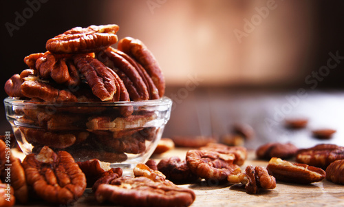 Composition with a bowl of shelled pecan nuts. Delicacies