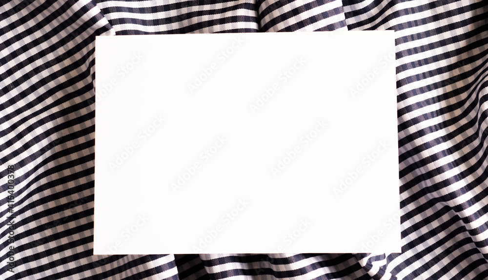 white sheet of paper against the background of crumpled fabric white sheet of paper against the background of crumpled fabric