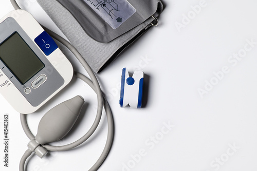 tonometer and pulse oximeter on white background