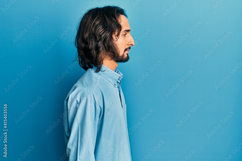 Young hispanic man wearing casual clothes looking to side, relax profile pose with natural face with confident smile. Young hispanic man wearing casual clothes looking to side, relax profile pose with natural face with confident smile.