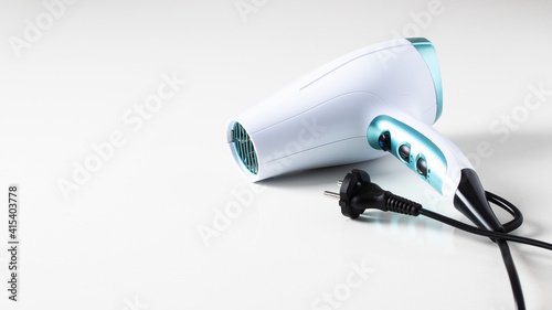 Ceramic ionic hairdryer on white background. Modern device for hairstyling large background for banner.Copy space