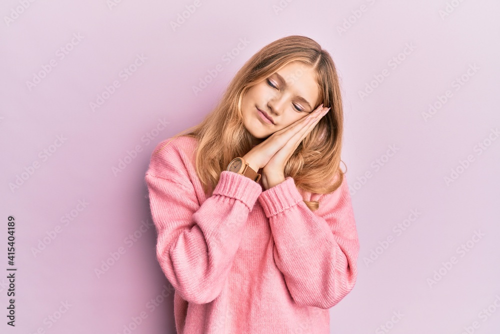 Beautiful young caucasian girl wearing casual clothes sleeping tired dreaming and posing with hands together while smiling with closed eyes. Beautiful young caucasian girl wearing casual clothes sleeping tired dreaming and posing with hands together while smiling with closed eyes.
