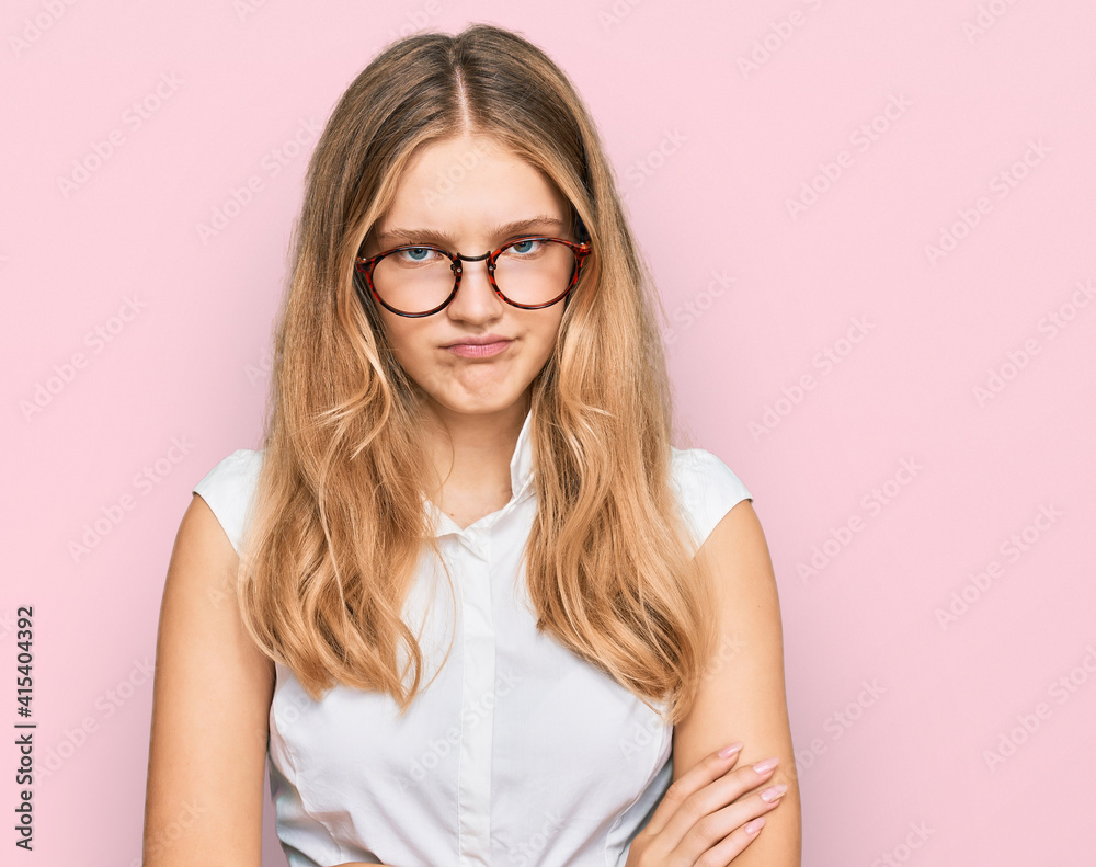 Beautiful young caucasian girl wearing casual clothes and glasses skeptic and nervous, disapproving expression on face with crossed arms. negative person.