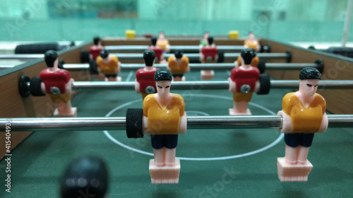 foosball table football game with red and yellow players