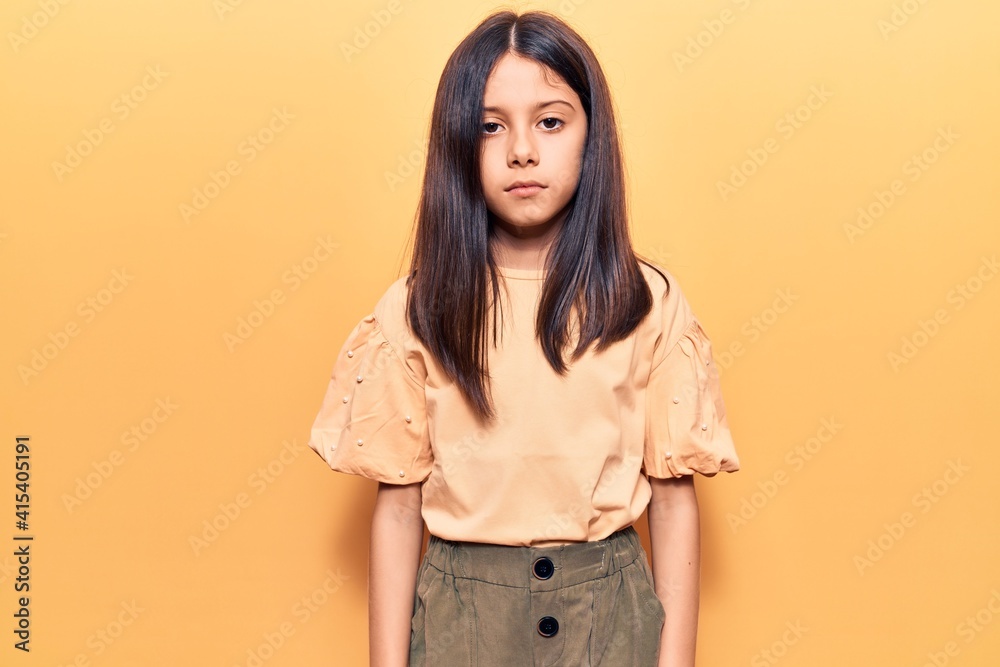 Beautiful child girl wearing casual clothes with serious expression on face. simple and natural looking at the camera. Beautiful child girl wearing casual clothes with serious expression on face. simple and natural looking at the camera.