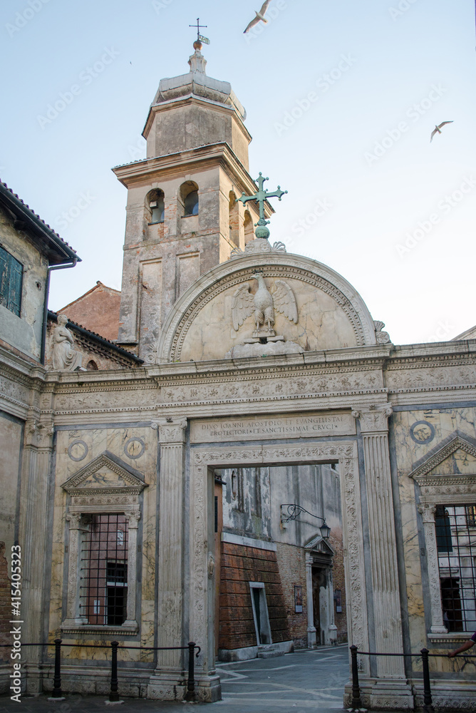 gates of a small ancient church in venice, history and religious