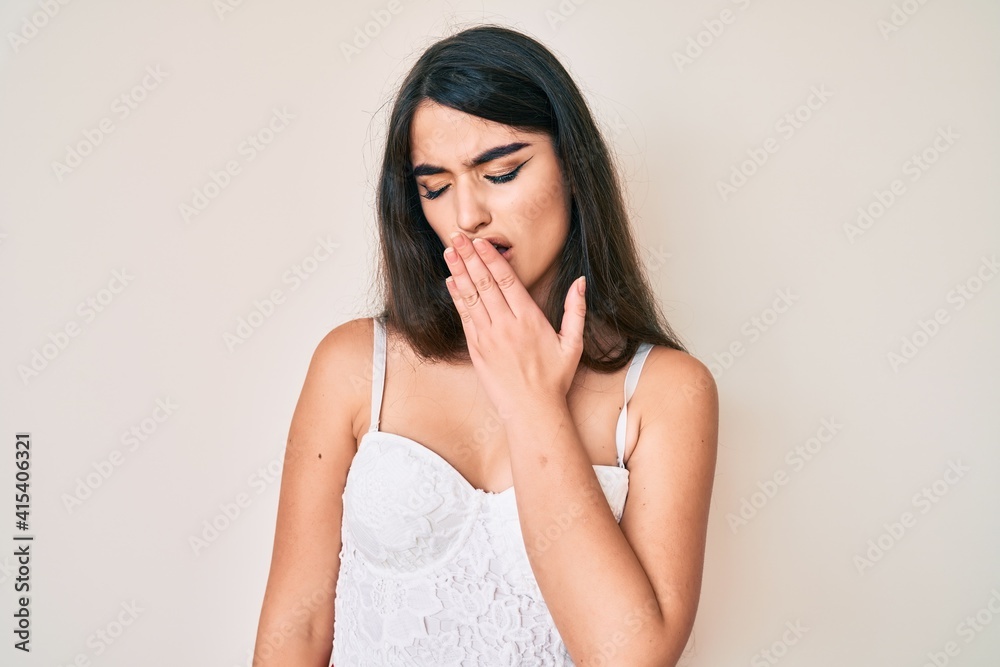 Brunette teenager girl posing elegant bored yawning tired covering mouth with hand. restless and sleepiness. Brunette teenager girl posing elegant bored yawning tired covering mouth with hand. restless and sleepiness.
