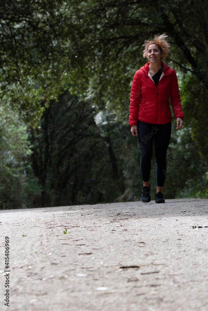 Portrait of a young woman taking a walk in the forest. Young woman doing sport. Portrait of a young woman taking a walk in the forest. Young woman doing sport.