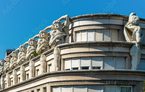 France, in Paris in the 12th arrondissement  an Art Nouveau building with on the roof top statues representing a dying slave.