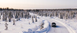 Bird’s eye view of vehicle car moving on rural road having good insurance for winter weather, aerial view of suv automobile driving in scenery area surrounded by coniferous forest.