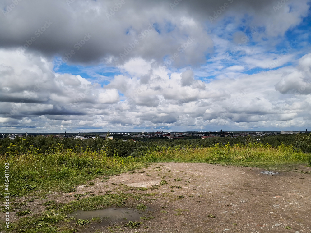 Landscape with white clouds. View from top of the hill. City as a miniature background. Landscape with white clouds. View from top of the hill. City as a miniature background.