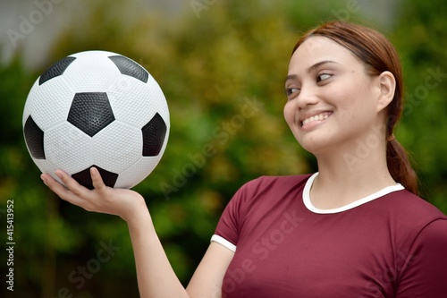 Sporty Redhead Female Smiling With Soccer Ball Outside © dtiberio